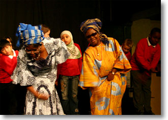African elders perform with children at the Tramshed Theatre